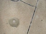 Eyelevel view of the disk set in concrete.
