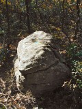 The reference mark on the wedge-shaped boulder.
