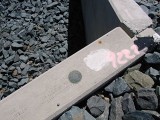 An eyelevel view of the mark set in the south end of the east concrete bridge headwall.