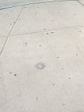 Eyelevel view of the disk in the sidewalk