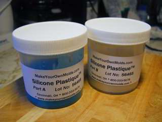 Jars of silicone molding material.