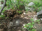View of the mark, cleared of debris, surrounded by rocks.