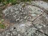 Disk on rock outcrop, with another drill hole in the foreground.