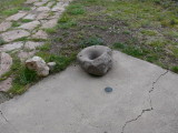 Eyelevel view of the bench mark disk, set in the concrete walkway around the ranch house.
