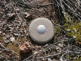 Eyelevel view of the reference mark disk in a round concrete monument.