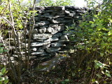 This is most likely the rock wall referred to in the description (or a new one built at the same spot). Notice all the 'gardening' Rich had to do so I could get in here!