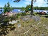 The rock outcrop is located in the picnic/outdoor seating area adjacent to Bagaduce Lunch.