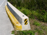 Eyelevel view of the mark set into the bridge curb.