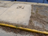 Eyelevel view of the tidal mark set in sidewalk.