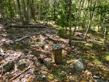 The monument is in open woods very close to the old bicycle path around Bear Brook Pond.