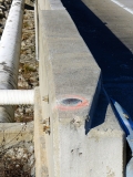 Eyelevel view of the disk on the bridge parapet.